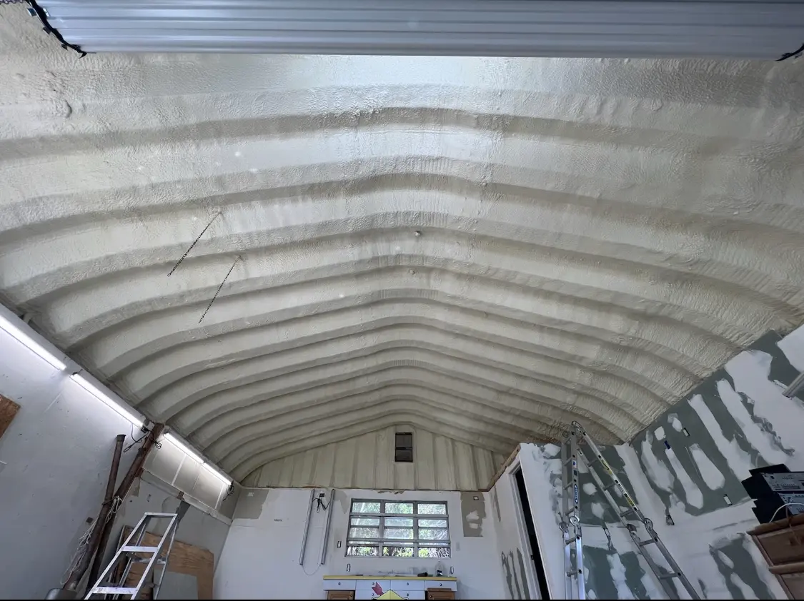 Spray polyurethane foam applied to the underside of a metal roof deck in Merriam